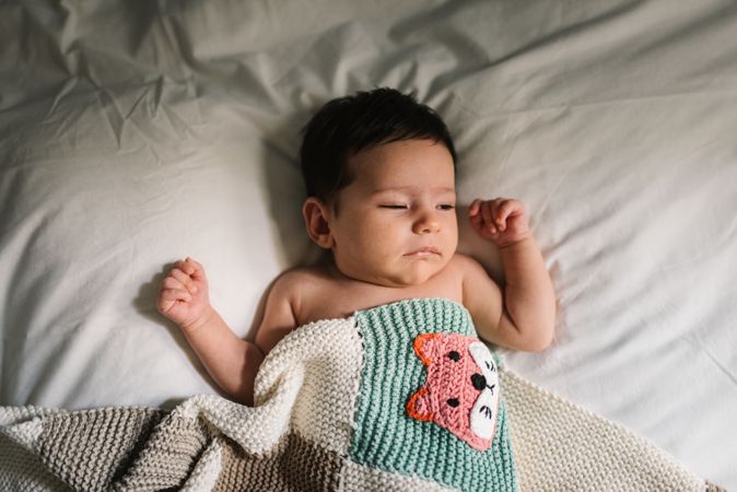 Cute baby sleeping on bed