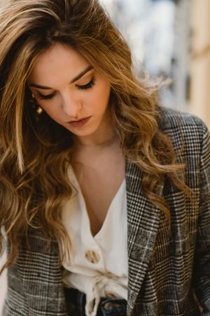 Woman leaning on wall on street