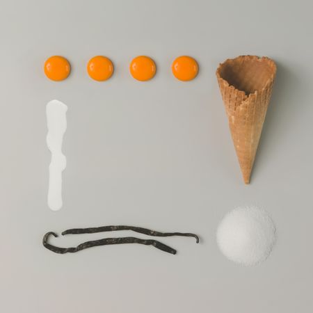 Deconstructed ice cream with egg yokes, vanilla beans, sugar, cream and waffle cone