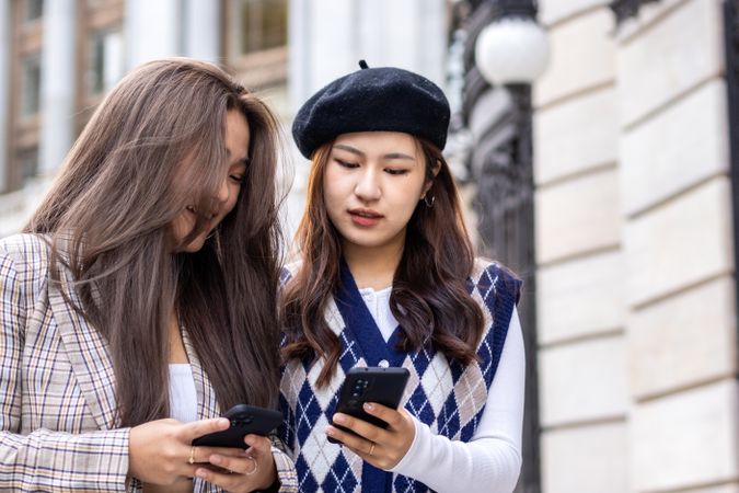 Young Asian Woman Walking and Using Smartphone in the City
