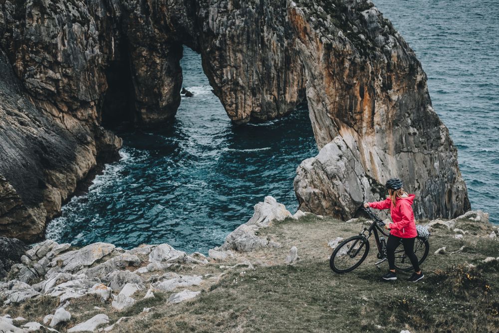 Female bicyclist on rocks