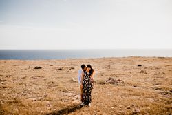Peaceful lovers bonding on empty coastline