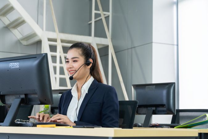 Woman speaking on headphones in call center