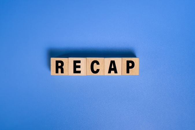 recap word text on wooden blocks isolated on blue background