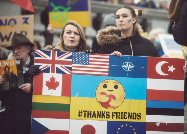 London, England, United Kingdom - March 5 2022: Two woman with multi-flag sign