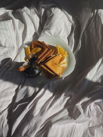 Plate of crepes in bed