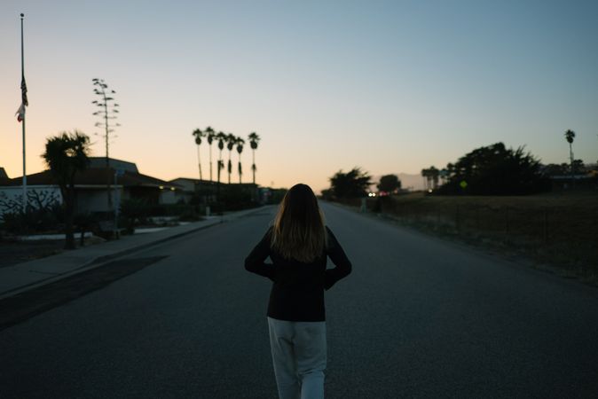 Back of woman walking down street in California