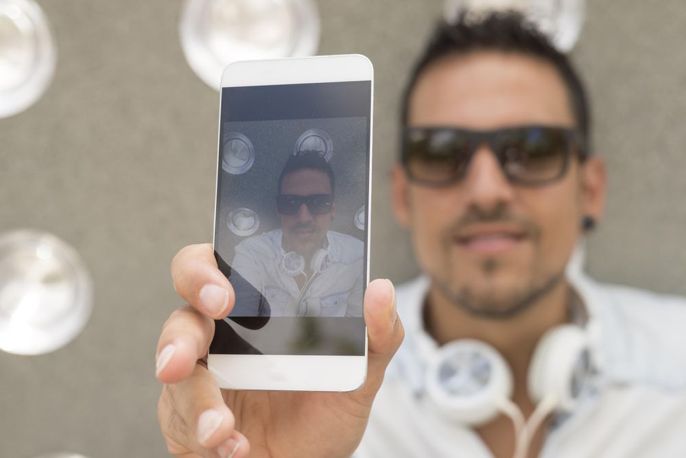 Happy man taking selfie