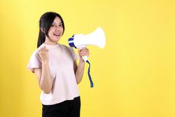 Indonesian Asian Excited Woman Shouting Holding a Megaphone