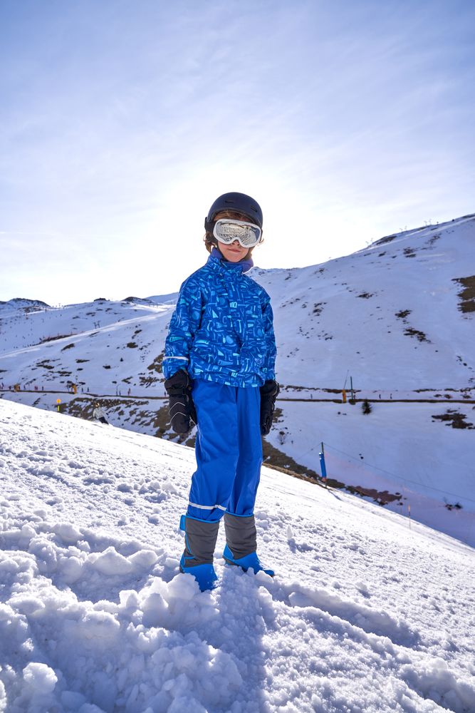 Boy spending time in snowy mountains