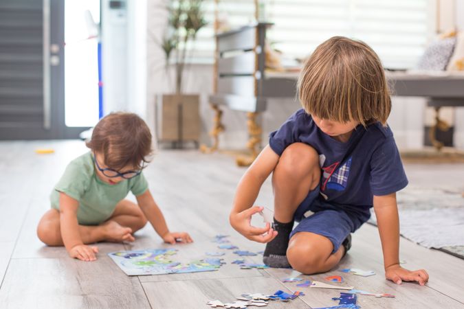 Two boys playing puzzles