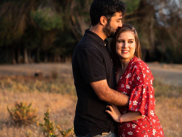 Young happy couple embracing in beautiful garden