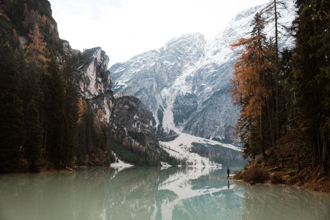 Man delighting in views near lake and mountains