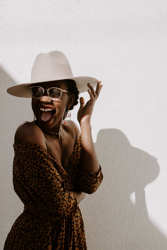 Woman laughing wearing a hat