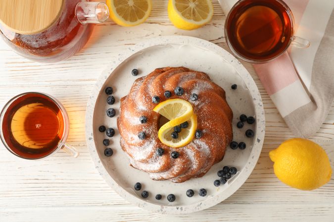 Cake with powder sugar and lemon, top view