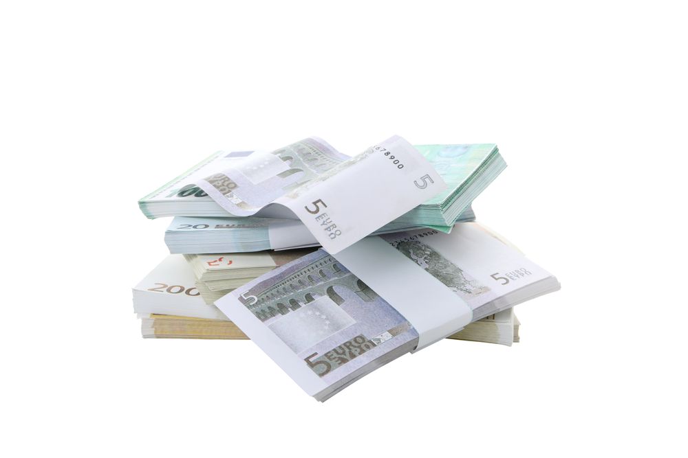 Stacks of American cash money, isolated on light background