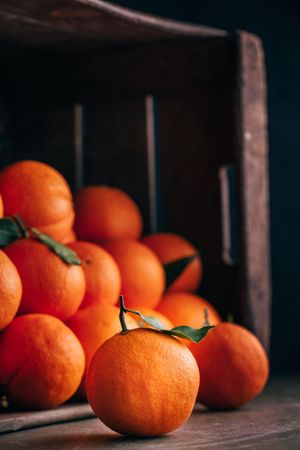 Fresh oranges in an old wooden box