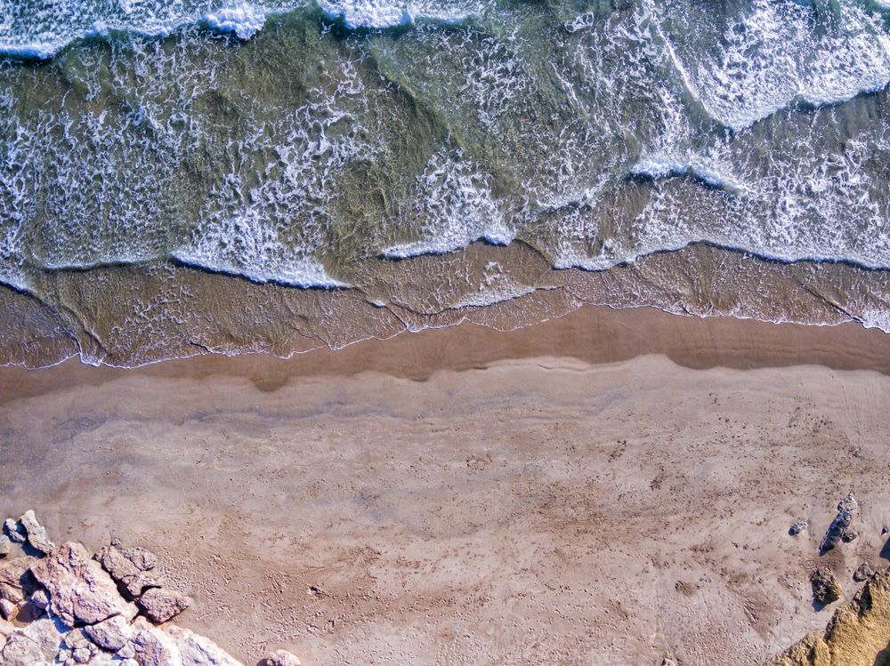 Looking down at beautiful beach with waves coming in