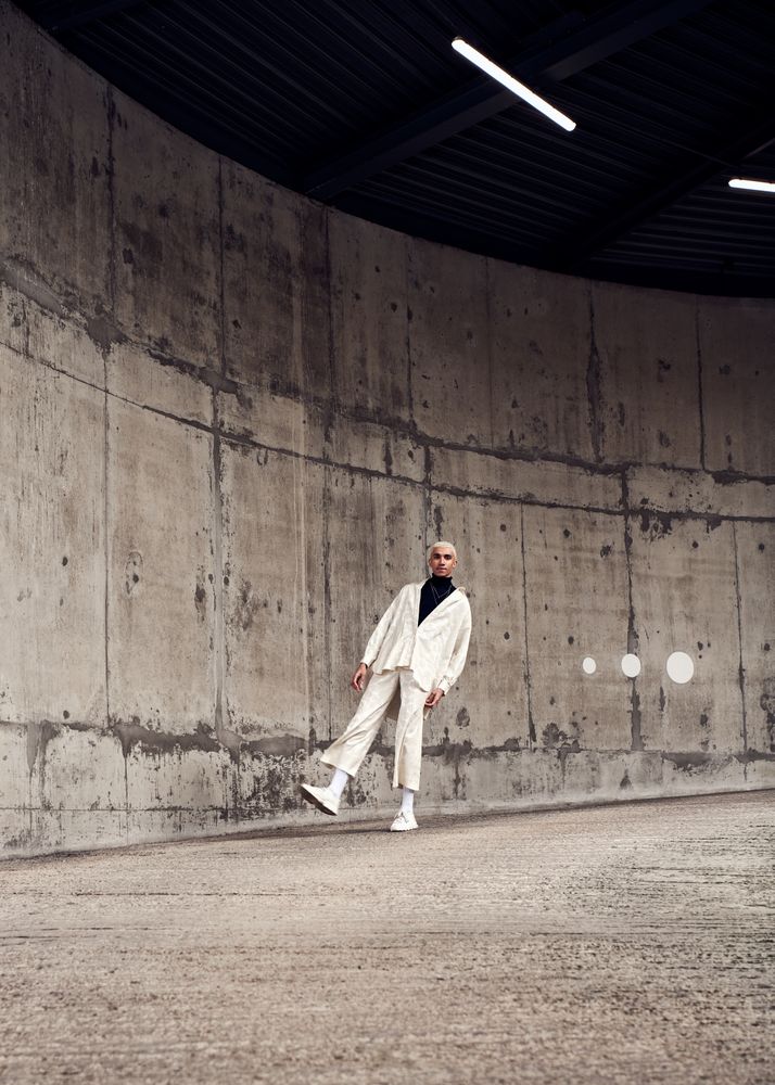Young man posing in lean back stance in cement structure