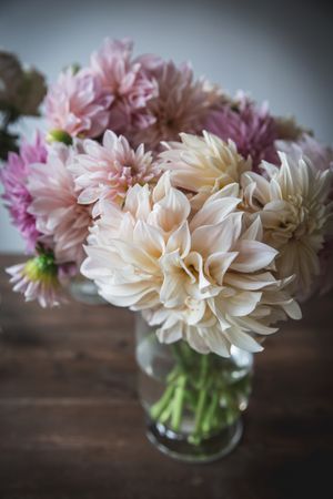 Bunches of flowers in vases on table