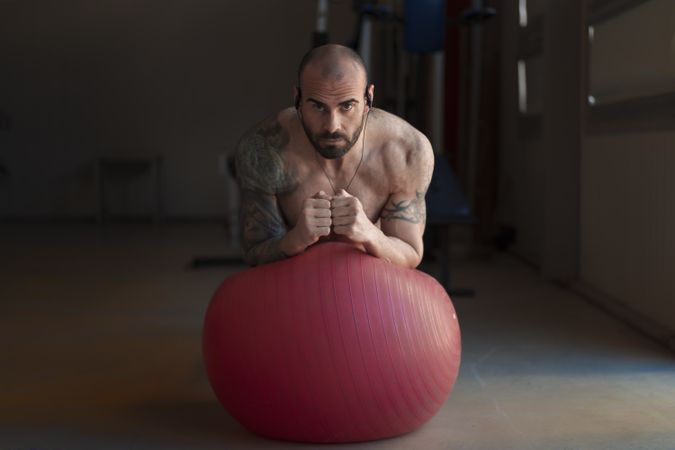 Serious male exercising with Swiss ball