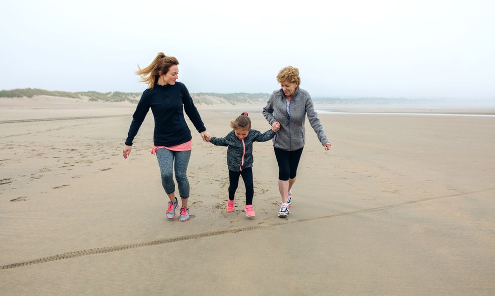 Three generations running on the beach