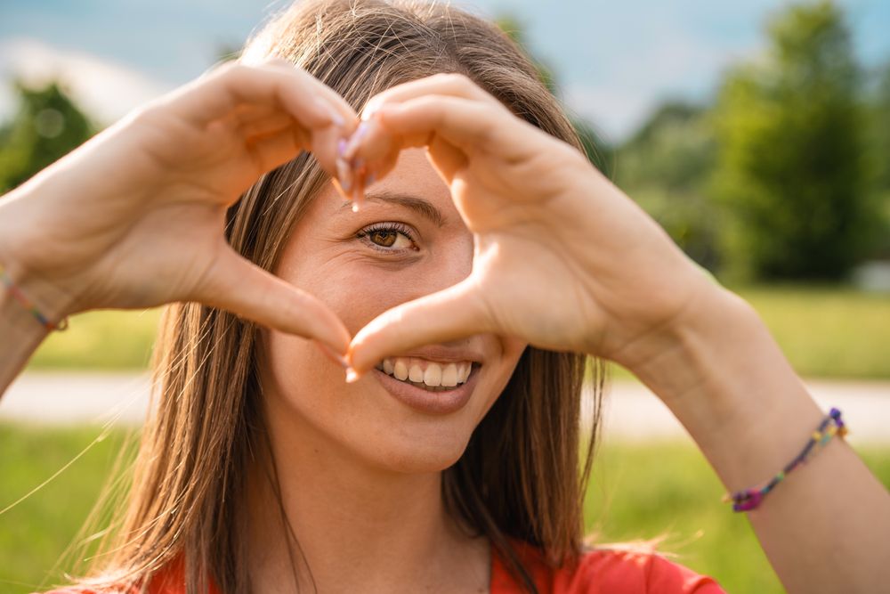 Woman making heart shape with hands