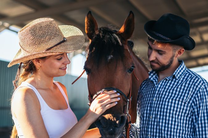 Friends walking with a horse in an equestrian center