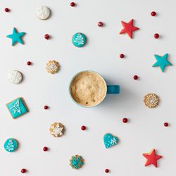 Christmas cookies and red berries with coffee cup