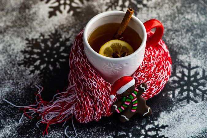 Cup of mulled tea wrapped in cosy scarf