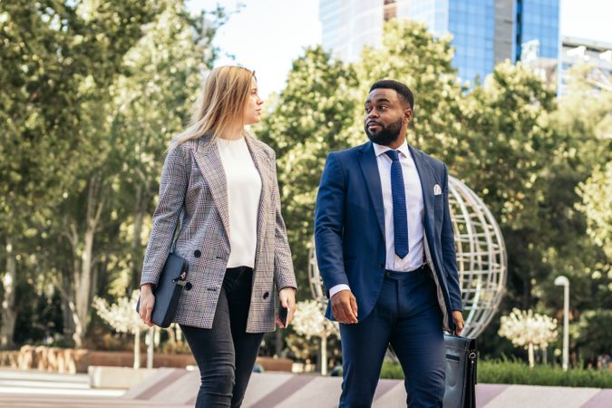 Coworkers talking about business outdoors