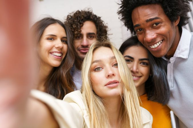 Friends smiling for a selfie outside