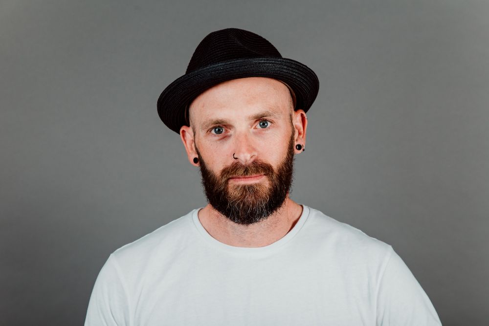 Young bald guy with hat