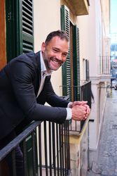 Cheerful adult businessman on balcony