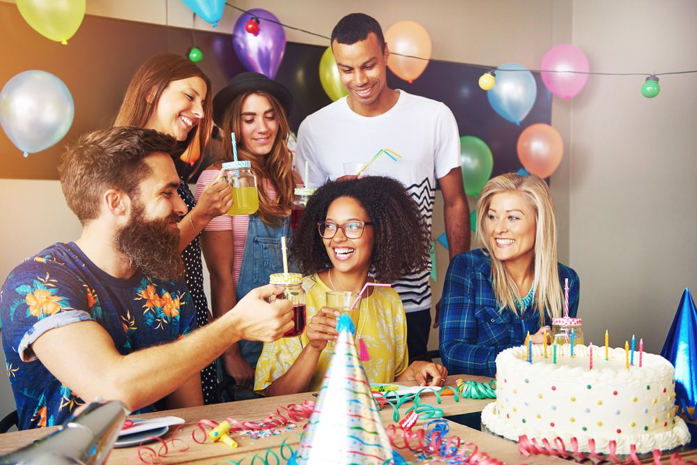 Group of friends celebrating a birthday for party indoors