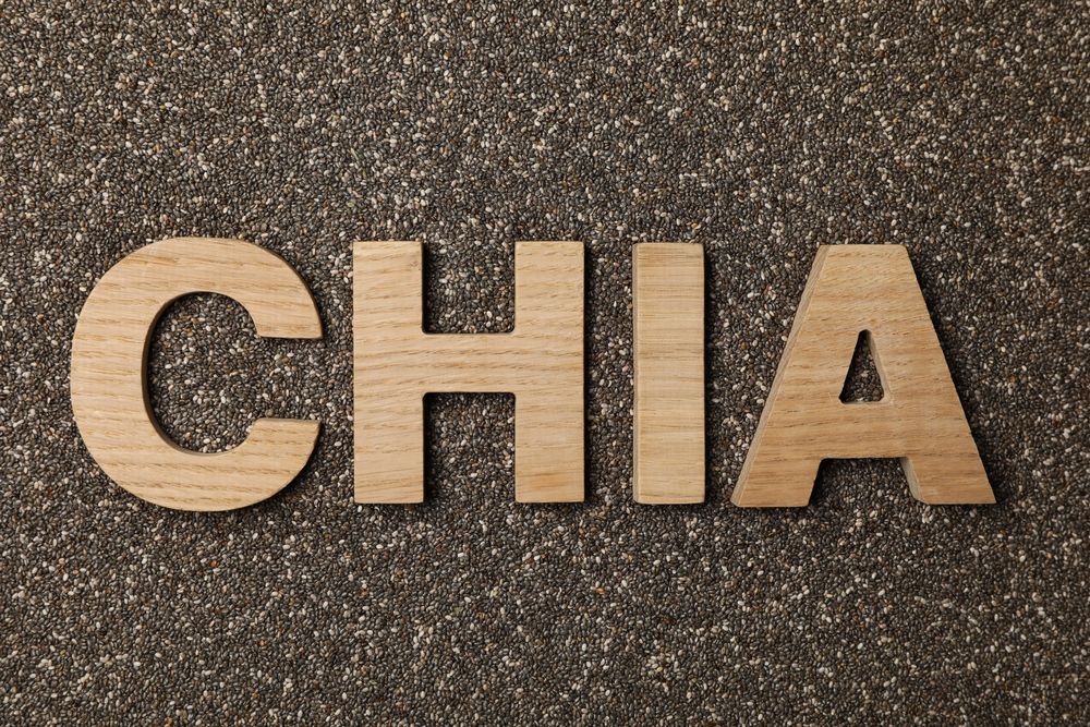 Word chia layout of wood letters on chia seeds background, top view