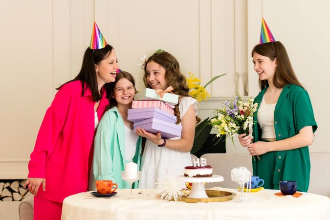 Girl in white dress receives gifts from family