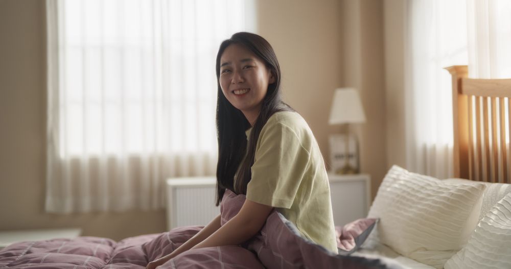 Portrait of a South Korean Woman Waking Up, Stretching and Looking Around the Room