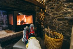 Feet being warmed by the fireplace
