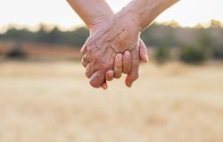 Two Generations Of Women Hold Hands