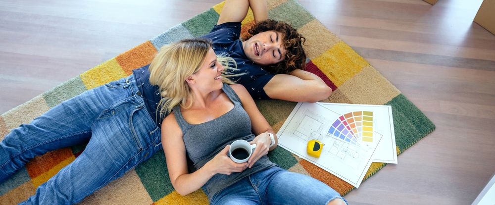 Couple resting lying on the carpet