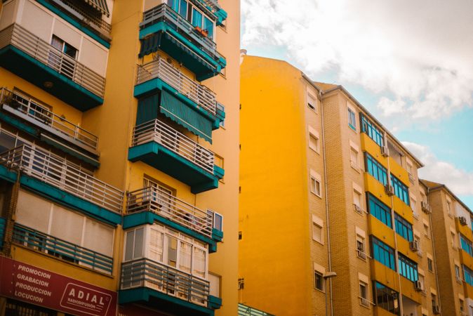 Cloudy sky over yellow apartment building