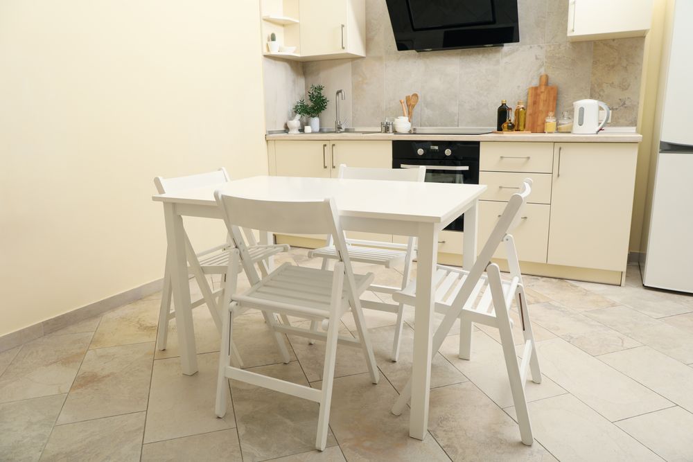 Kitchen interior with wooden table and folding chairs