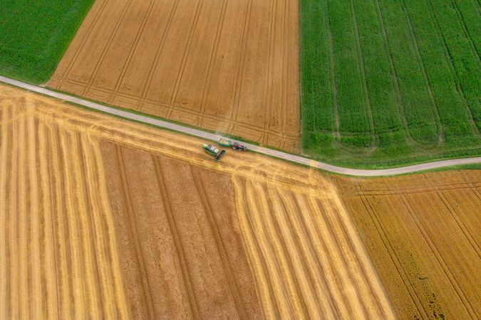 Drone image with a combine harvesting crop in Germany in the evening