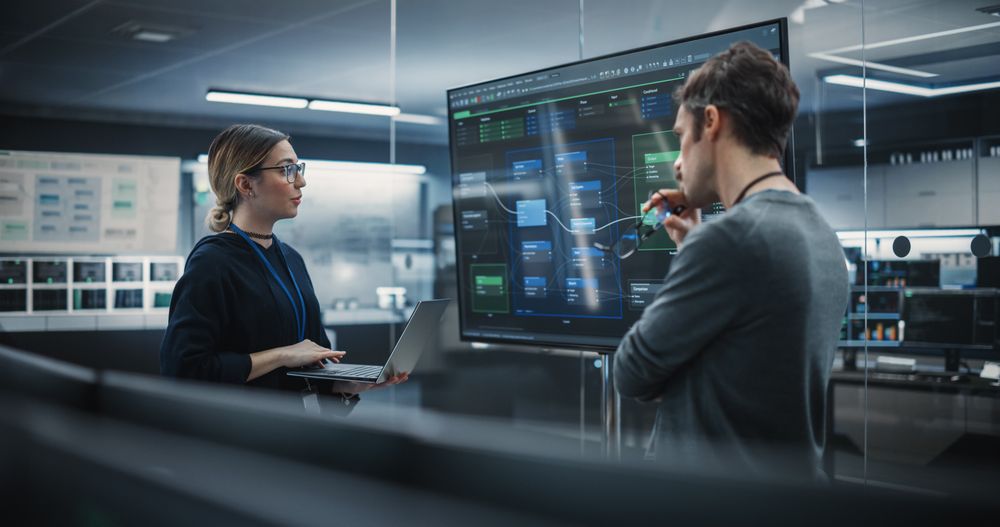 Two Diverse Software Developers Having a Meeting in a Conference Room.
