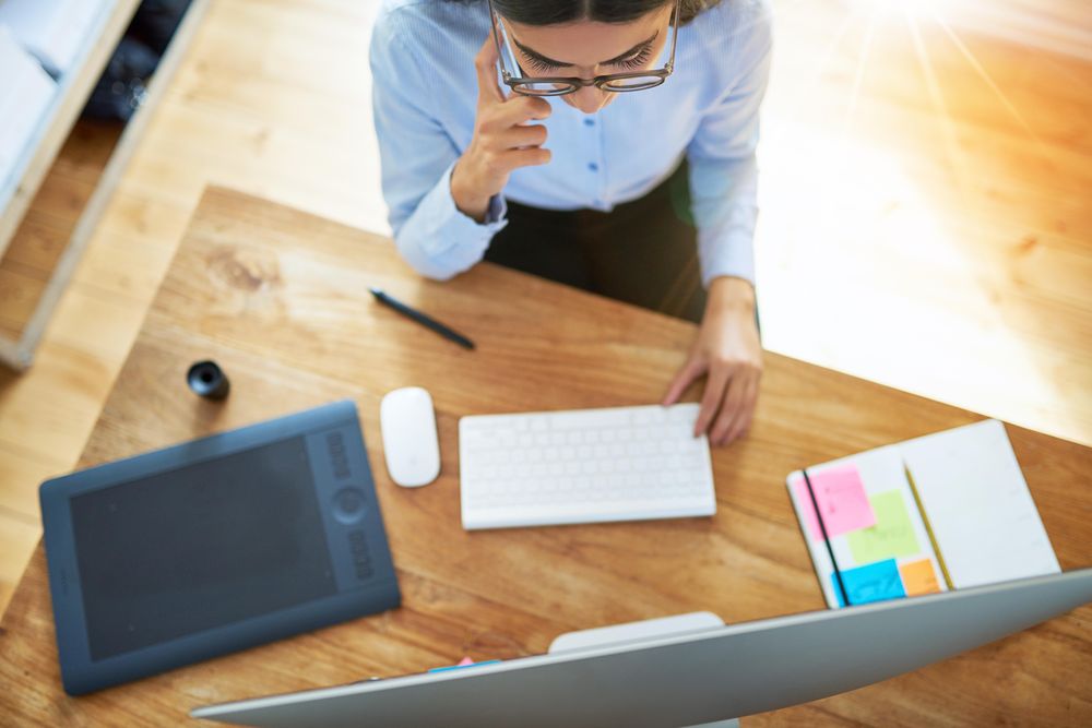 Looking down at woman entrepreneur working from home taking a phone call