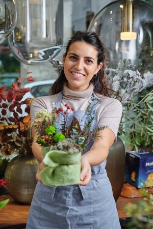 Woman demonstrating flower bouquet and smiling