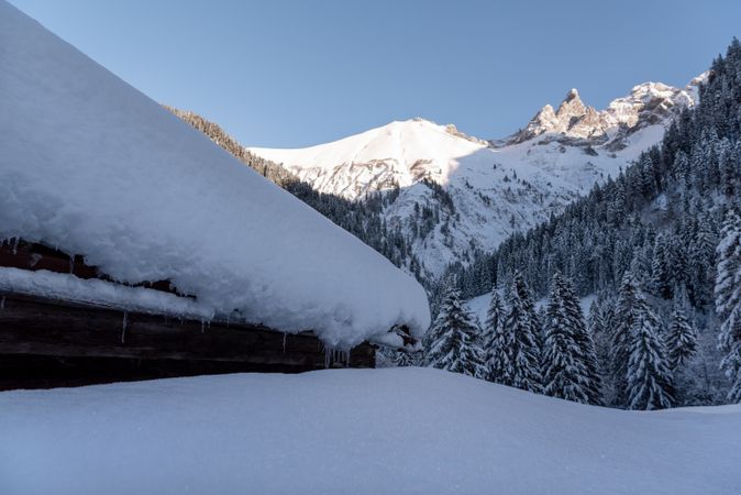 Snow-covered rustic mountain cabin in the Bavarian Alps, in Germany