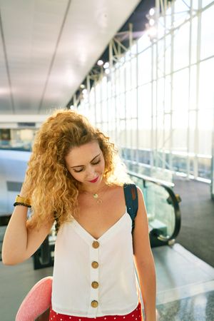 woman walking in spacious hall in sunlight