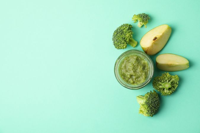 Vegetable puree on mint background, top view